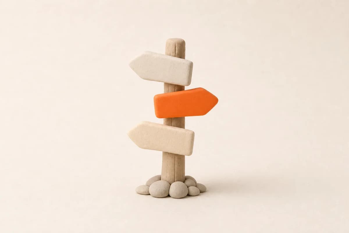 A wooden signpost with three blank arrow boards pointing different ways, one in orange.